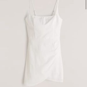 Scoop neck wrap mini dress in white worn 1x